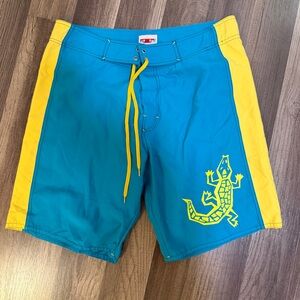 Tactics board shorts. Blue with yellow lizard.  Surf life skater M
